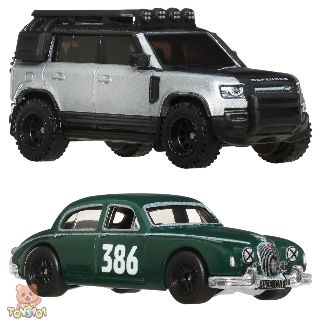 Two toy cars, one silver Land Rover Defender and one green Jaguar Mark 1, on a white background.