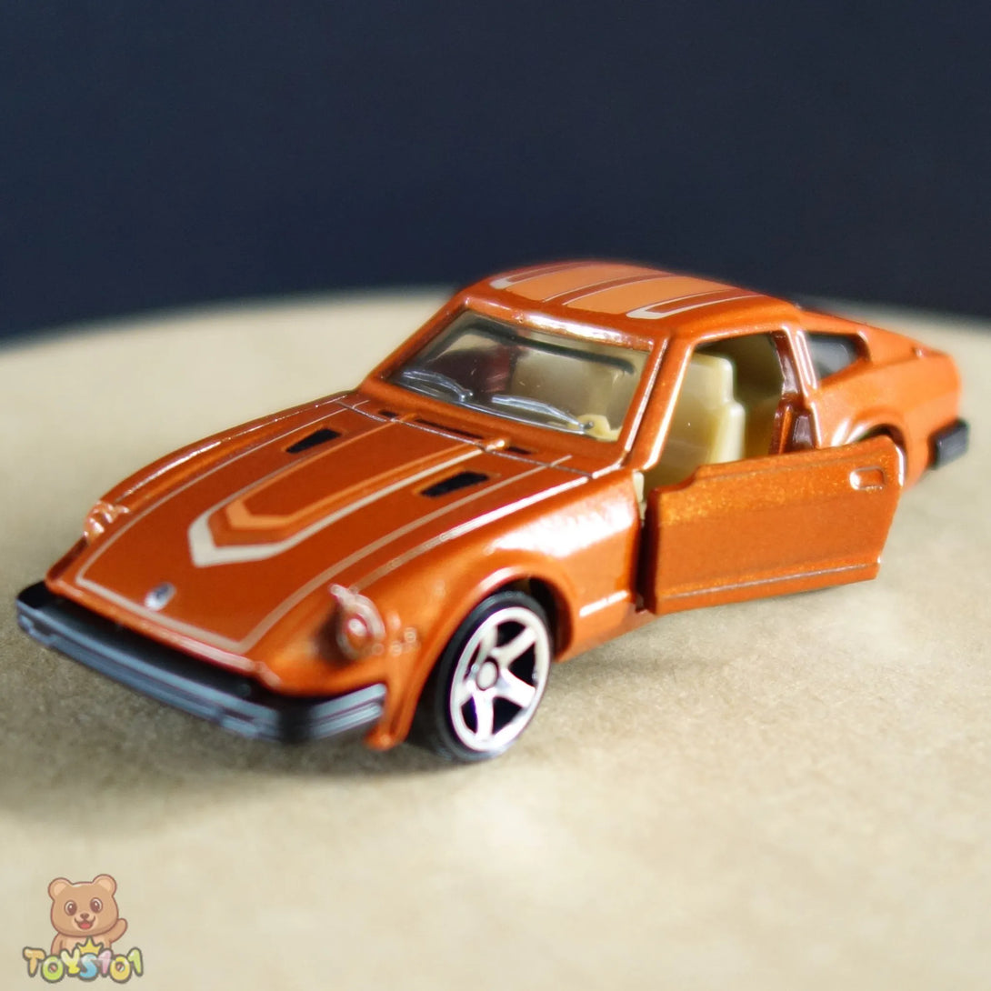 Orange 1:64 scale diecast Nissan 280ZX by Matchbox displayed with driver's door open.