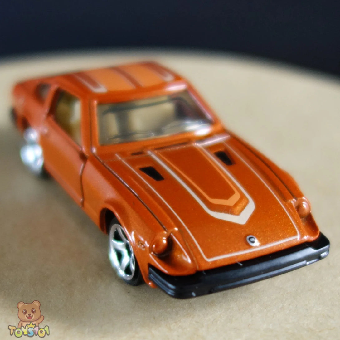 Orange 1:64 scale diecast Nissan 280ZX by Matchbox viewed from the front.