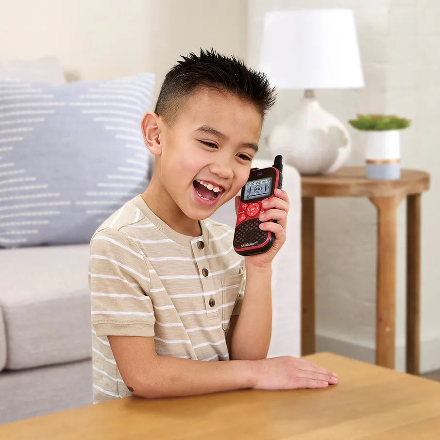 Child holding a VTech brand walkie-talkie in a living room setting