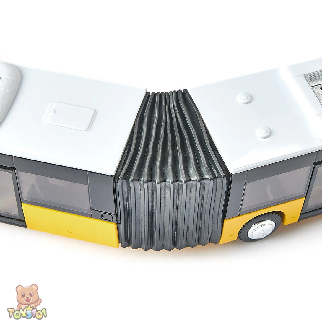 Close-up of a toy bus with a folded section on a white background